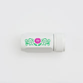 A white cylindrical pencil sharpener with a textured screw-on cap, featuring a decorative green scroll pattern and a pink flower graphic on the side, set against a plain white background.