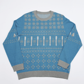 Blue and grey sweater with a pencil and snowflake pattern on a white background