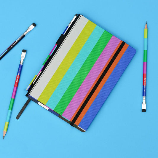 Blackwing 343 volume notebook and pencils, featuring the NTSC test pattern colorblock, on a blue background