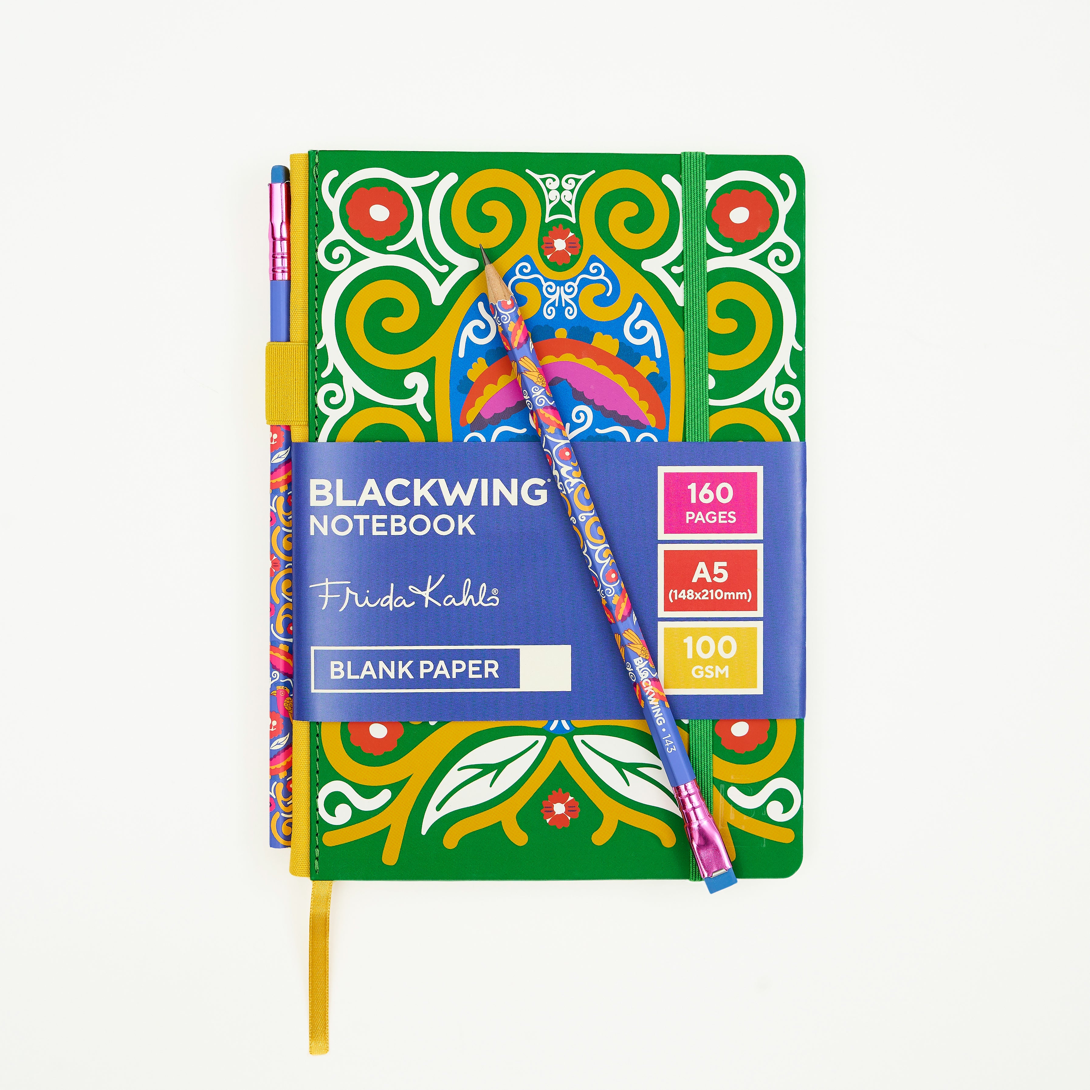 A Blackwing Notebook with a vibrant green cover decorated with a colorful yellow, white red, pink, and blue pattern, wrapped with a blue paper band and accompanied by a matching patterned pencil, on a clean white background.