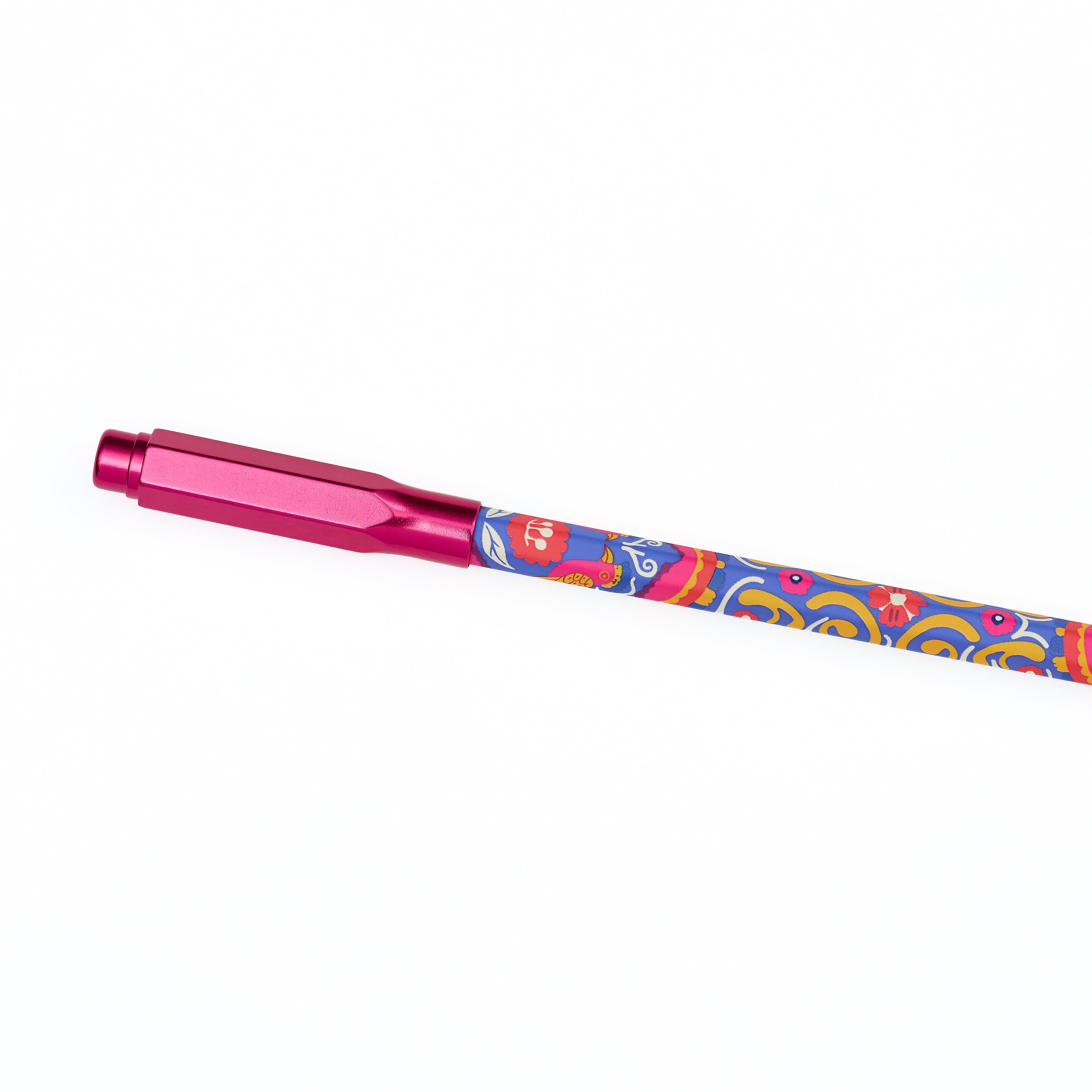 A metallic pink pencil point guard attached to the end of a colorful patterned pencil featuring blue, orange, and yellow swirls, shown diagonally on a plain white background.