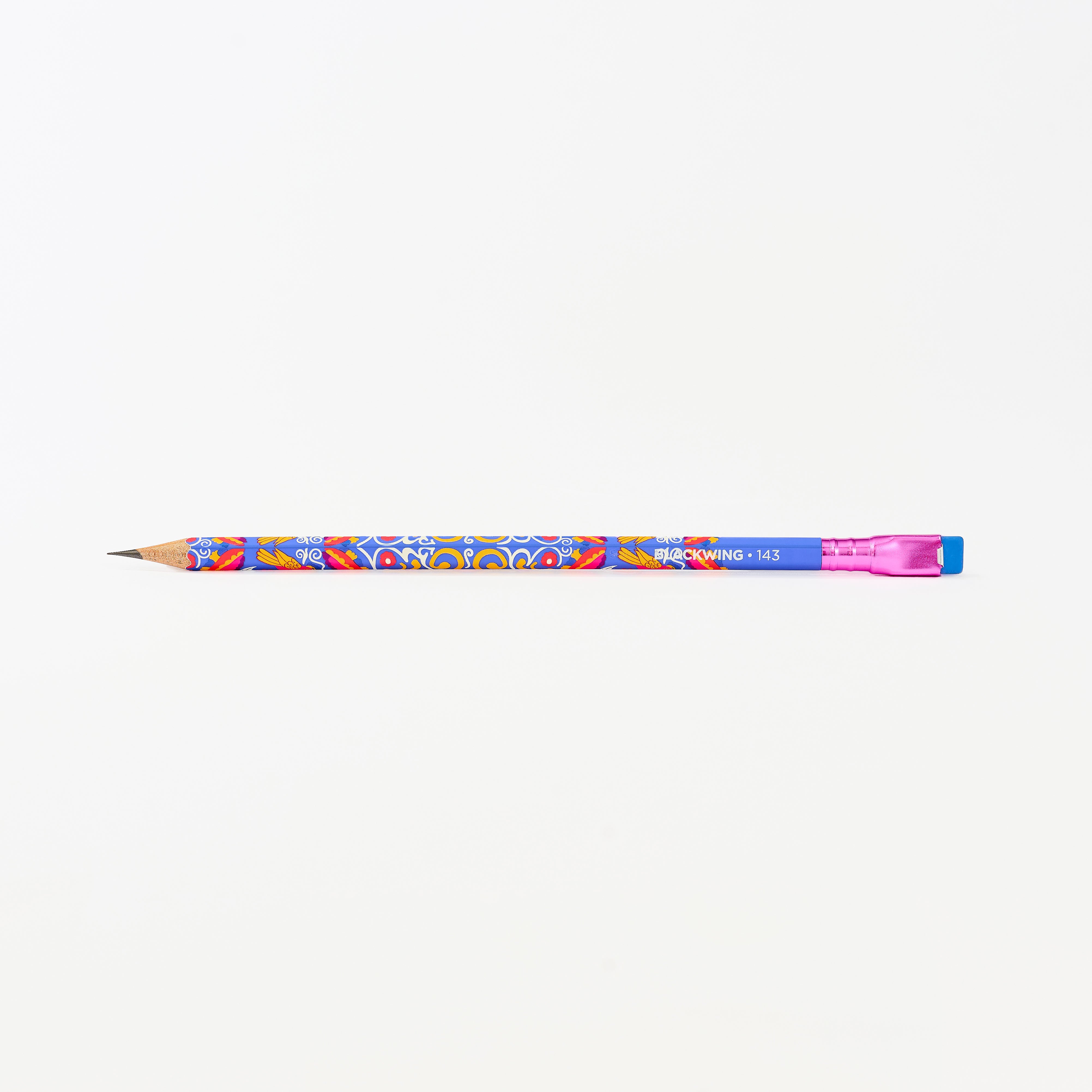 A colorful wooden pencil with a blue body, vibrant multicolor floral pattern, a pink ferrule, and a blue eraser shown horizontally against a plain white background.