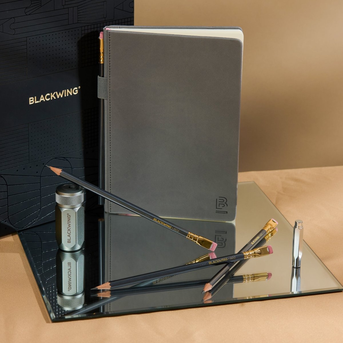 Blackwing Notebook Essentials Set with grey hardcover notebook, 602 pencils, silver one-step sharpener, and silver point guard