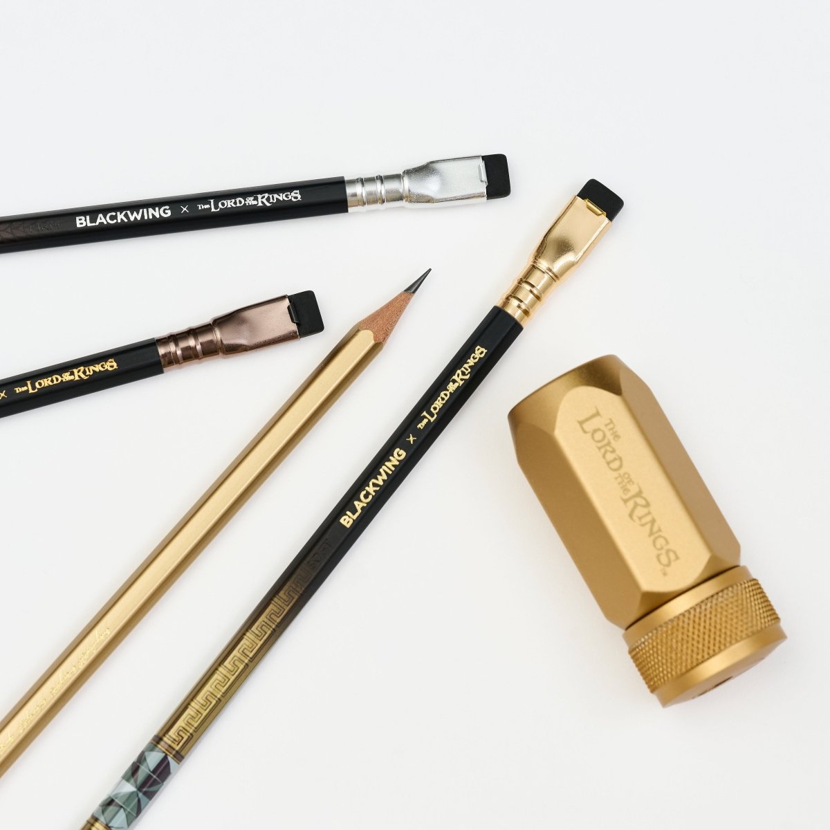 Set of Lord of the Rings Blackwing pencils and a gold sharener on a white background