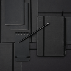 black pencil on top of black notebooks and notepads
