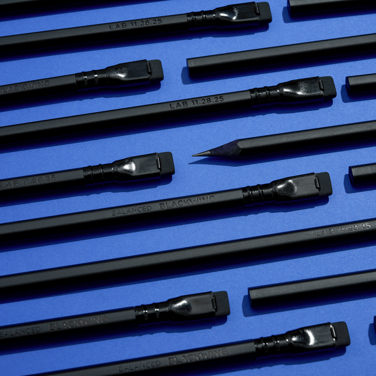 black pencils on a blue background
