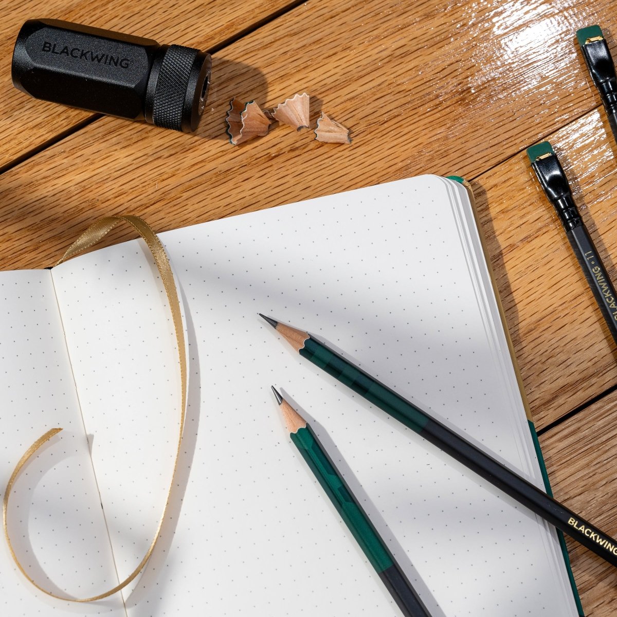 Blackwing Volume 11 Bill Russell Notebook laying open with pencils and sharpener