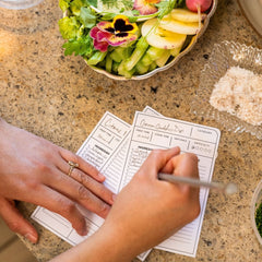 Person writing with a Blackwing Volume 140 culinary pencil on a recipe card