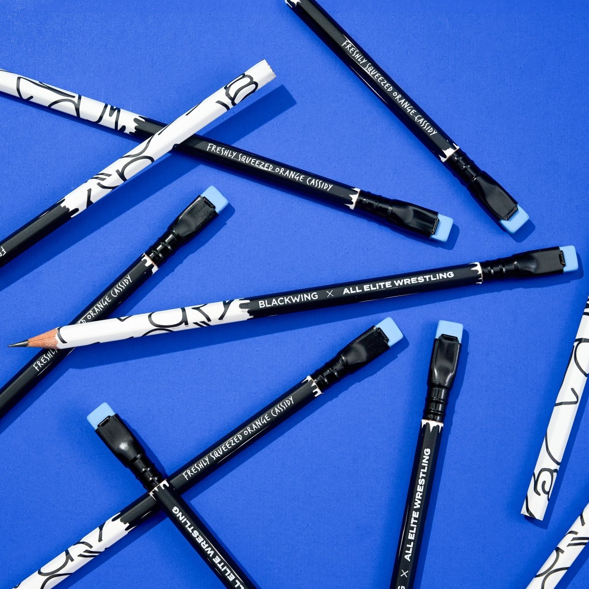 Blackwing pencils with wrestling-themed designs on a blue background