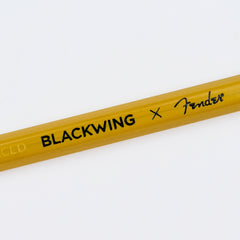 A close-up of a yellow Blackwing x Fender pencil from the butterscotch collection, showing the 'BLACKWING x Fender' branding printed in black, on a clean white background.