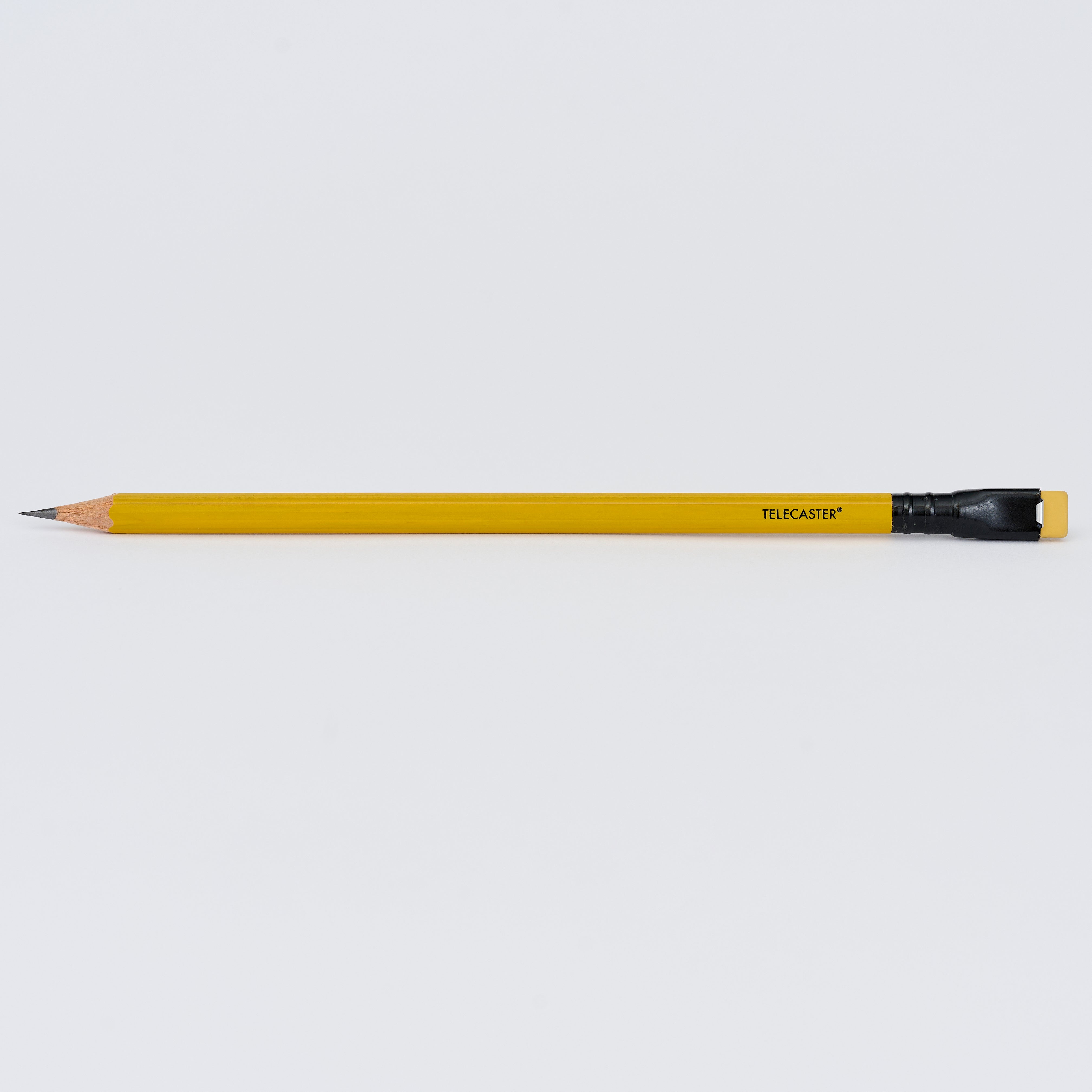 Yellow pencil with 'TELECASTER' imprinted in black near the top, featuring a black ferrule and yellow eraser - from the Blackwing x Fender Butterscotch collection