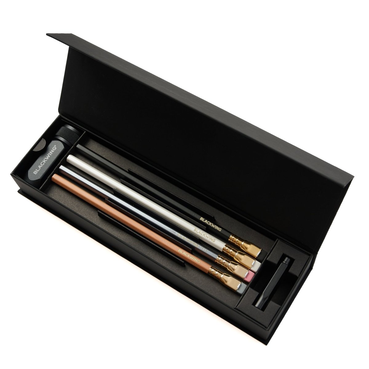 Set of Blackwing core pencils in a black case with a pencil point guard and sharpener.
