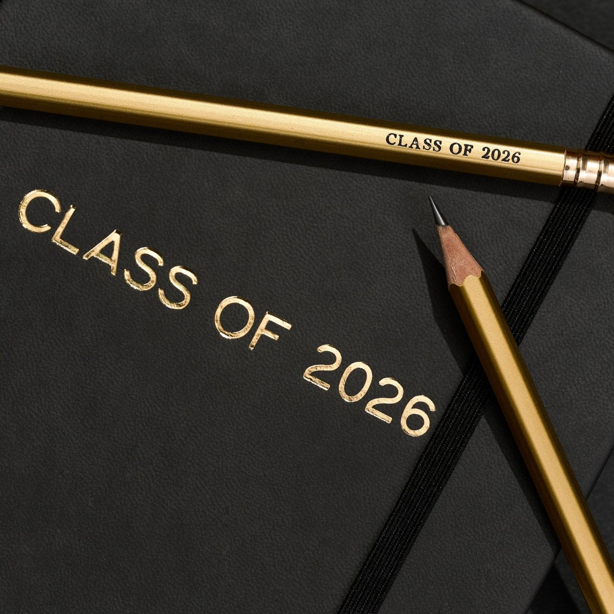 class of 2026 graduation present, includes a black notebook and gold pencils