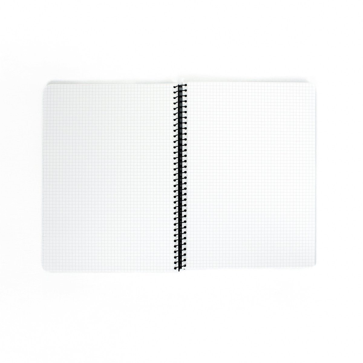 Blackwing A4 Spiral Notebook with graph paper laying open on a white background