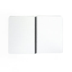 Blackwing A4 Spiral Notebook with graph paper laying open on a white background