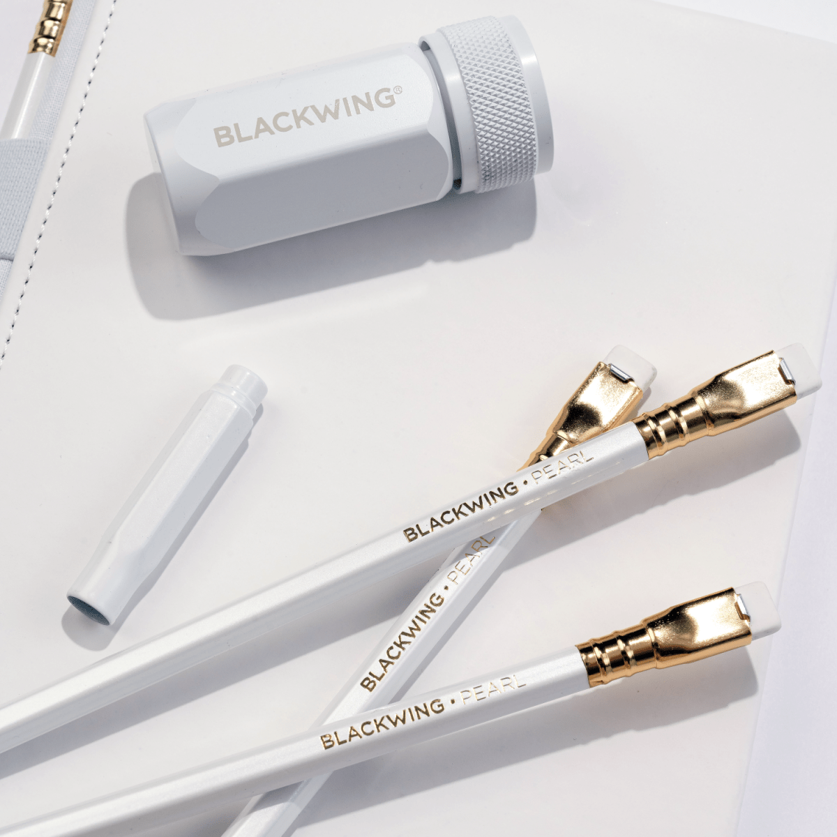 Blackwing white one-step sharpener, white pencil guard, pearl pencils, and white slate notebook