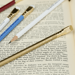 Blackwing pencils in red, white, blue, and gold, each with imprint 'THE BETTER ANGELS OF OUR NATURE' on top of an open book