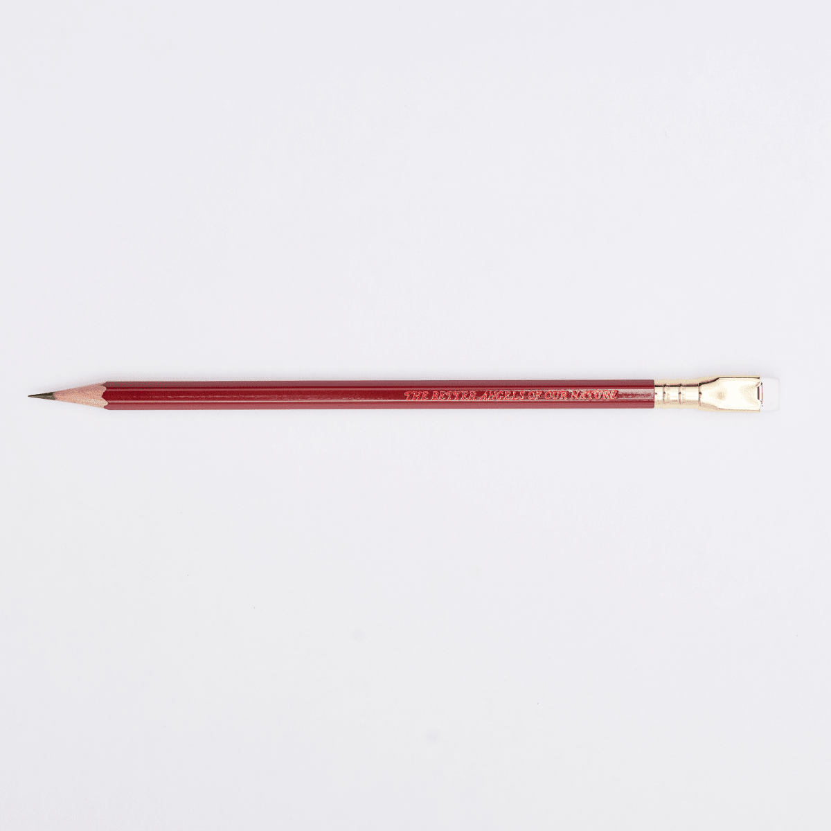 red pencil sharpened on a white background with pencil barrel text 'THE BETTER ANGELS OF OUR NATURE'.
