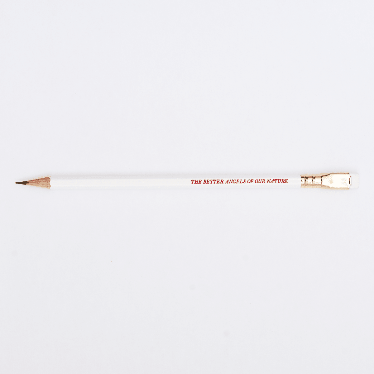 white pencil sharpened on a white background with pencil barrel text in red that says 'THE BETTER ANGELS OF OUR NATURE'.