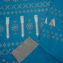 Blue sweater with winter pattern featuring trees, snowflakes, and pencils.