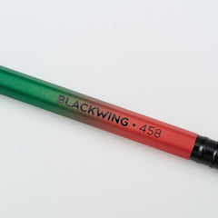 Blackwing Volume 458 pencil with green and red barrel, black imprint, and black ferrule