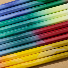 gradient birding pencils in four designs lay side-by-side, creating the shapes of bird silhouettes