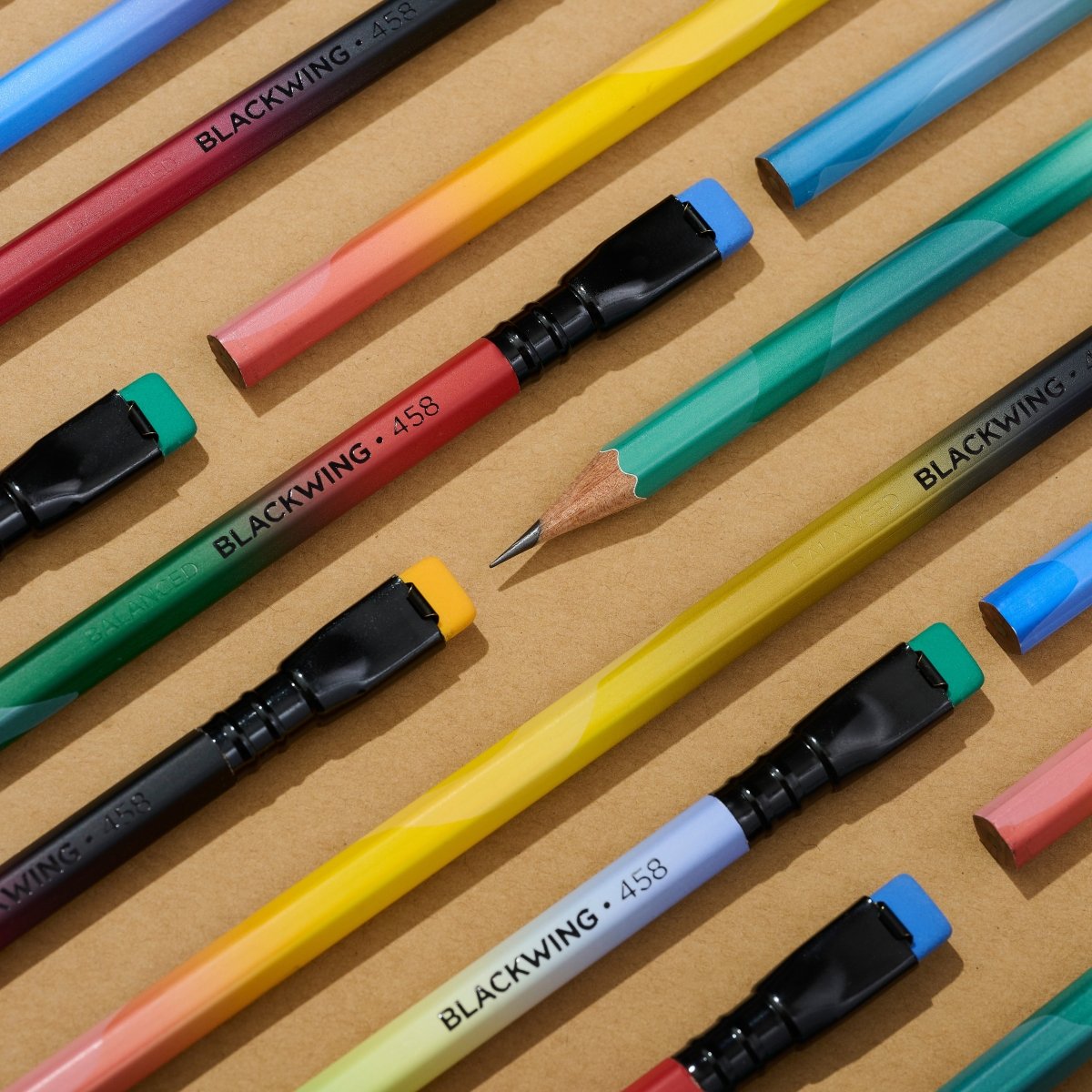 Blackwing Volume 458 pencil arranged in a pattern on a tan background
