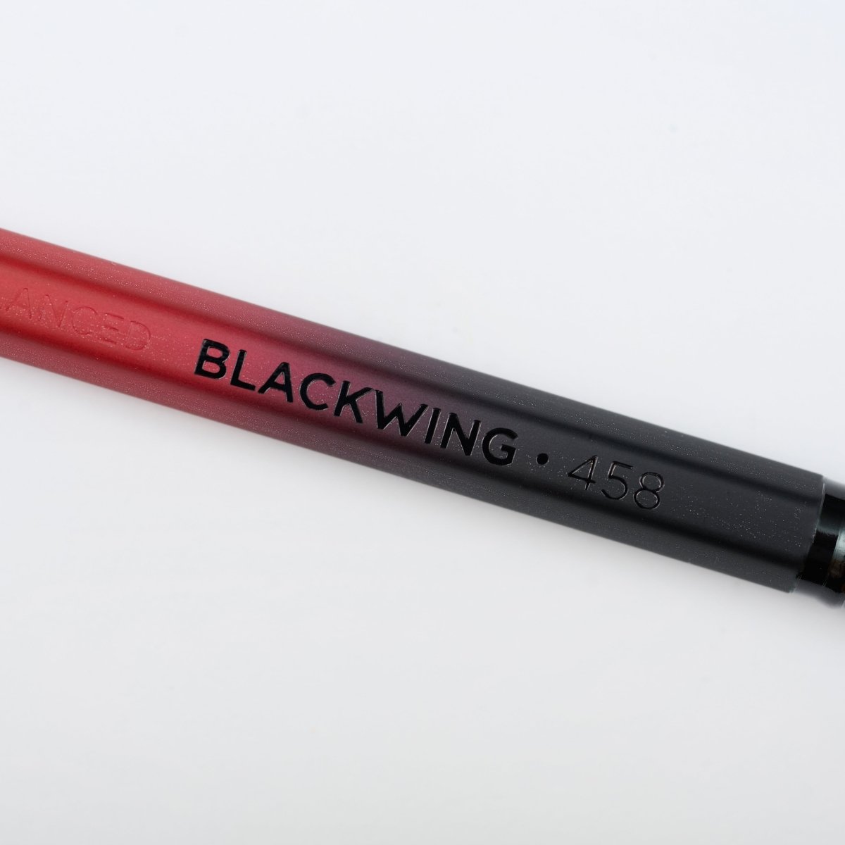 Blackwing Volume 458 pencil with red and black barrel, black imprint, and black ferrule