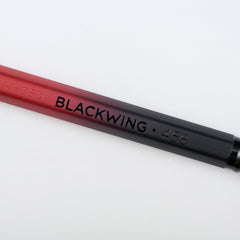 Blackwing Volume 458 pencil with red and black barrel, black imprint, and black ferrule