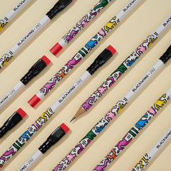 Blackwing Vol. 292 Keith Haring Pencils with dancing illustration at an angle on an off white background
