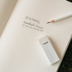Blackwing Soft Handheld Eraser in white on a notebook