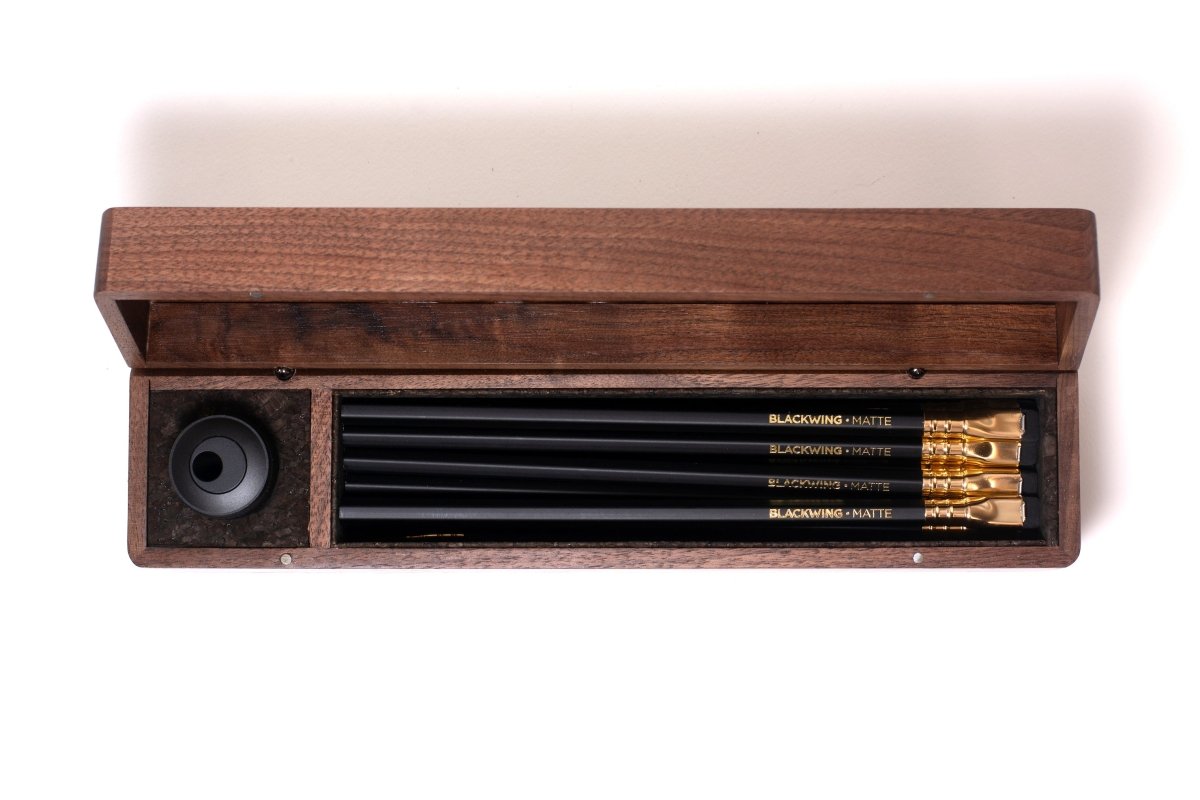 A Blackwing Walnut Box with a sharpener and 12 pencils included