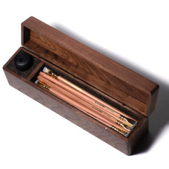 A Blackwing Walnut Box with Blackwing natural pencils in it.