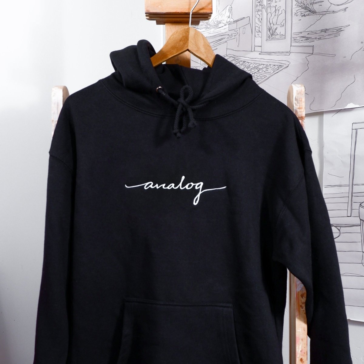 black hoodie with white "analog" cursive text 