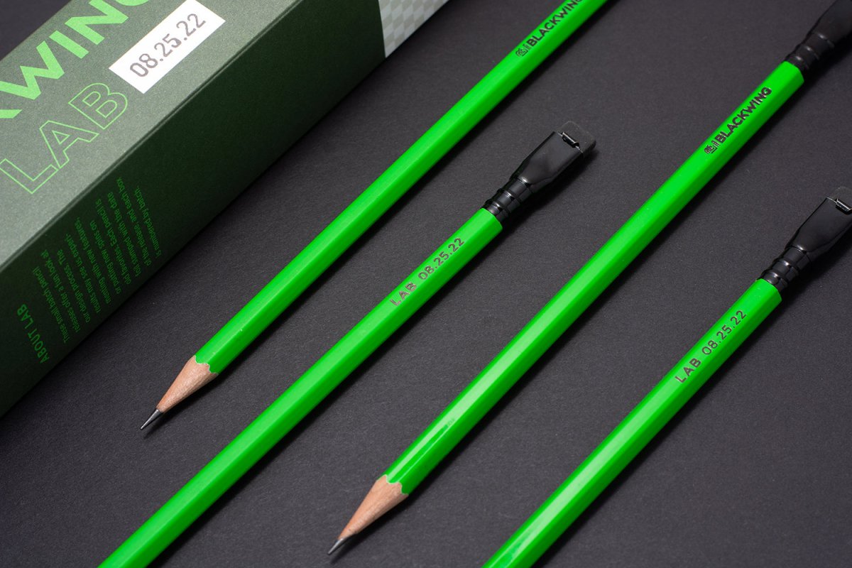 A set of Blackwing Lab 08.25.22 green pencils next to the packaging