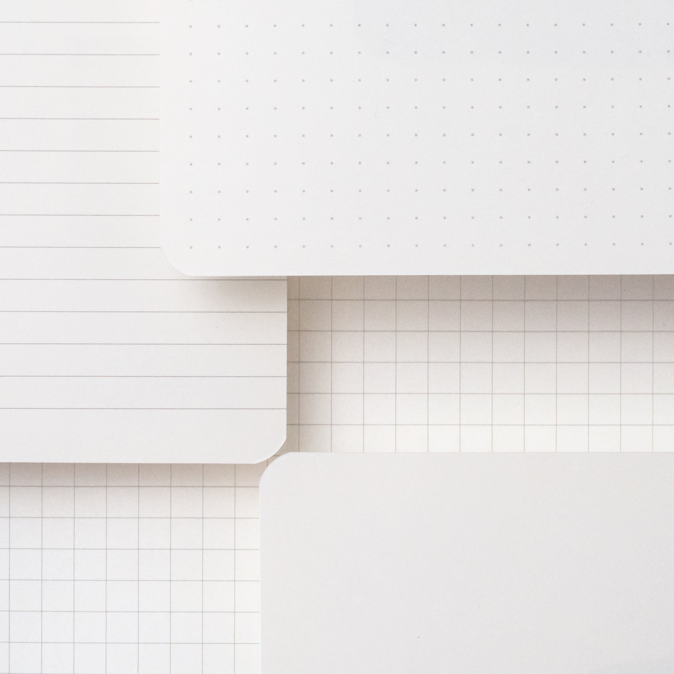 A stack of Large Blackwing Slate Notebooks showcasing paper types - dot-grid, blank, ruled, and graph