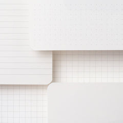 A stack of slate notebooks - available in dot-grid, ruled, blank, and grid