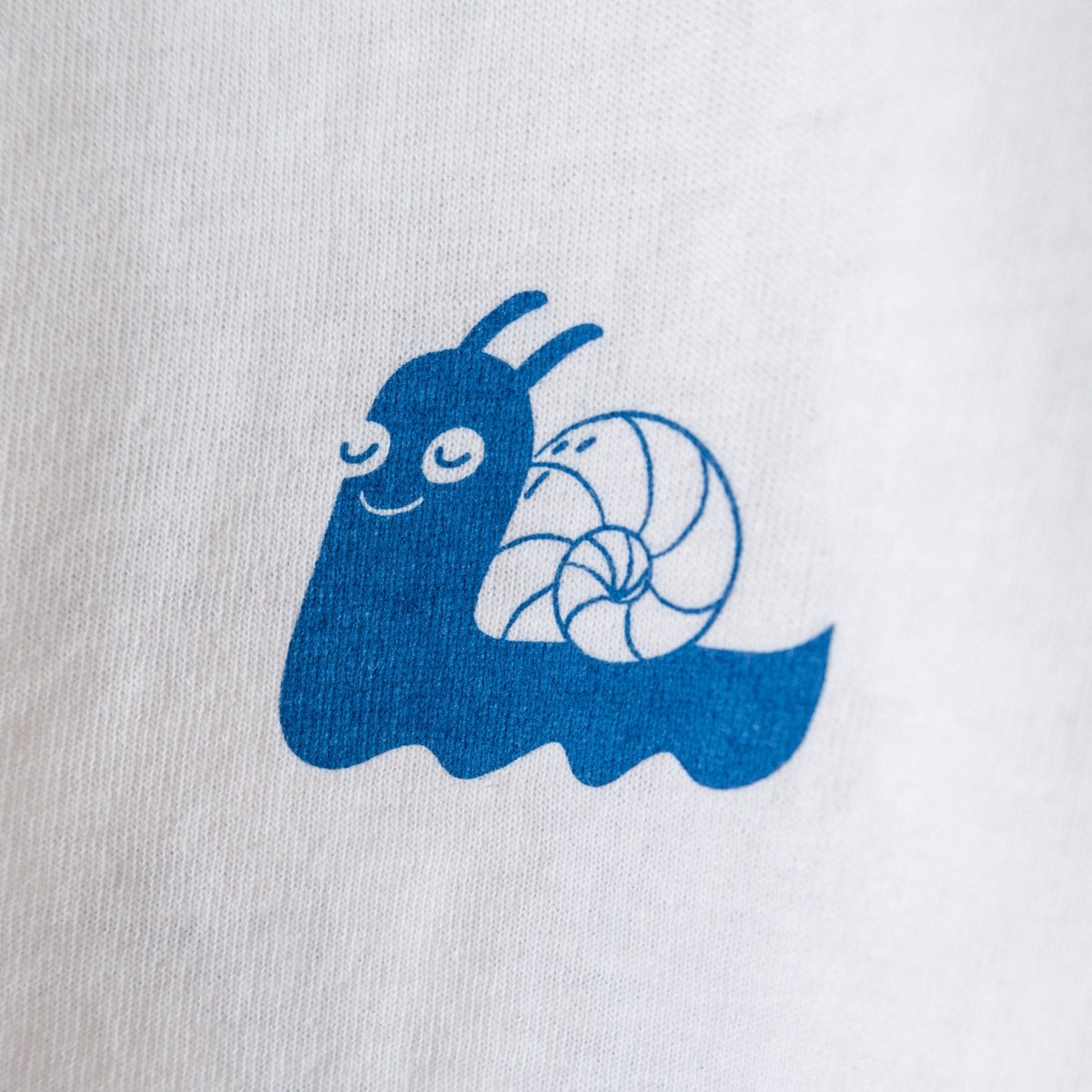 white slow-down t-shirt screen printed snail on left breast